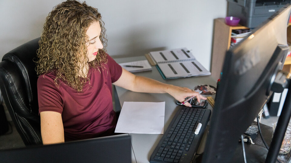 Female farmer working on a computer