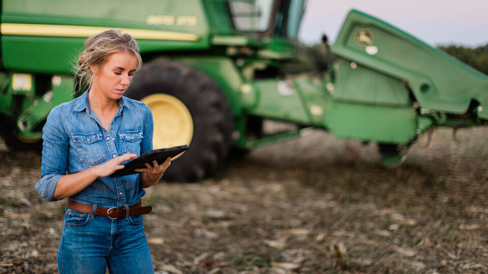 Female farmer looking at tablet in a field