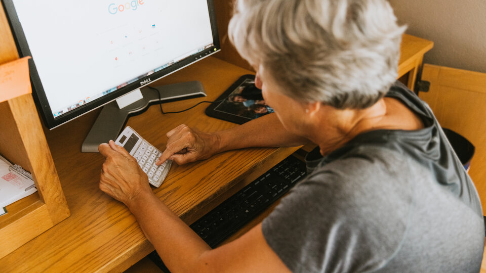 Female farmer calculating numbers 